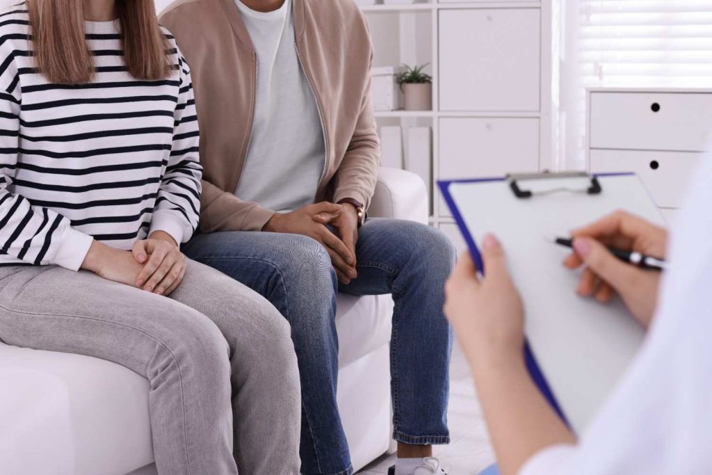 Couple consulting with a medical professional, symbolizing affordable and cheap STD testing in Gulfton.